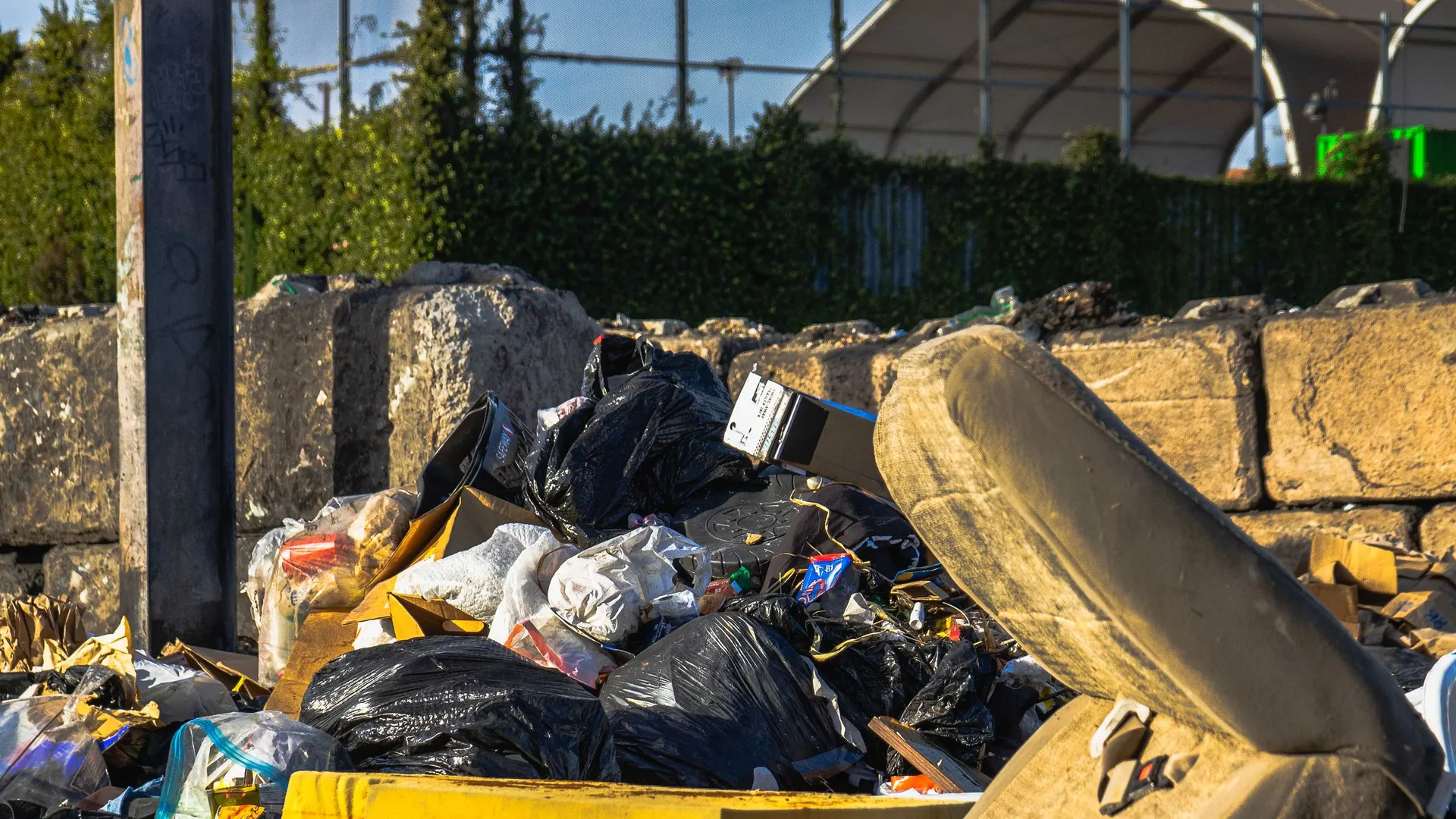 Pile of household junk and a discarded mattress waiting for pickup